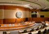 Redefining Personhood: Unborn Children’s Rights at Risk Interior view of a government chamber with wooden paneling and seating