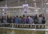 DOJ-DHS Crackdown: Who ‘Lost’ These Kids? People sitting on benches inside a fenced facility.