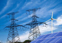 Water Wars Hit Data Giant Power lines, solar panels, and wind turbine against sky.