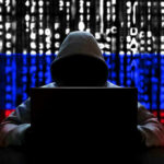 Charity Branding, Hamas Ties, and a San Diego Defendant Hacker in hoodie with Russian flag background and code.