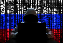 Charity Branding, Hamas Ties, and a San Diego Defendant Hacker in hoodie with Russian flag background and code.