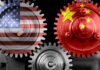 Pentagon Drops $500M Bomb On China Grip Interlocking gears with USA and China flags.
