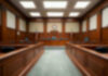 Empty courthouse courtroom with wooden benches and chairs.