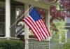 HOA Picked a Fight It May Not Win American flag hanging from a porch.