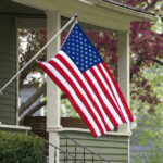 HOA Picked a Fight It May Not Win American flag hanging from a porch.