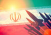Silhouettes of missiles over Irans flag graphic.