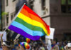 Pride Just Exposed a Crack Democrats Can’t Hide People holding and waving a rainbow flag.