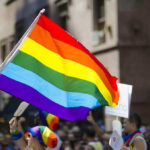 Pride Just Exposed a Crack Democrats Can’t Hide People holding and waving a rainbow flag.