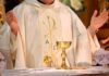 Why Catholic Men Were Told Not To Pray At Cathedral A priest holding a golden chalice during a religious ceremony