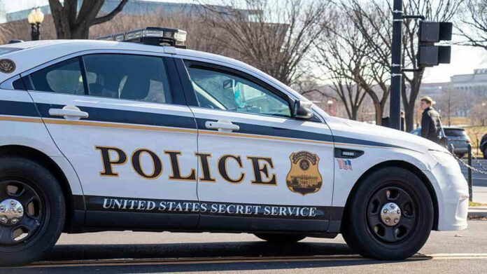 1606745311 United States Secret Service police car on roadside.
