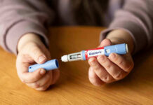 TRICARE Trap: Weight Loss Shot Vanishes Hands holding an Ozempic injection pen.