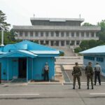 Israel’s Wild Ask—Washington Went Quiet Military personnel standing near blue buildings at a border crossing