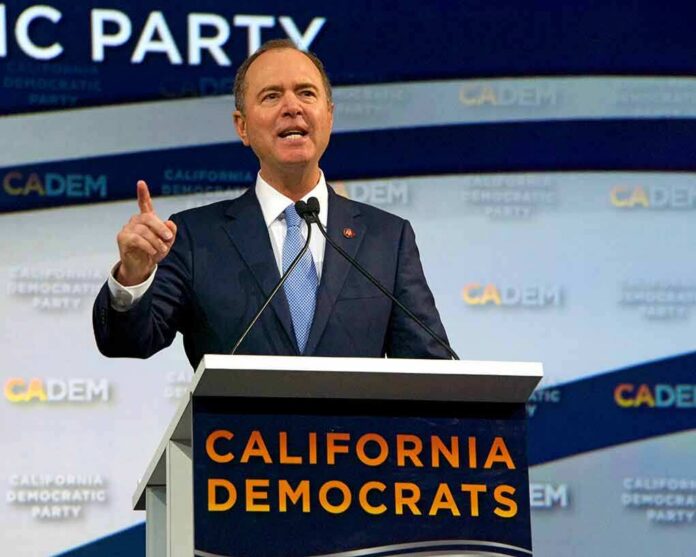 Man in suit speaking at a podium with microphones