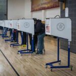 Election Lies Mint Millions — The Game Exposed Voters at polling booths in a gymnasium