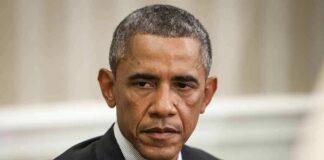 man in a dark suit looking to the side
