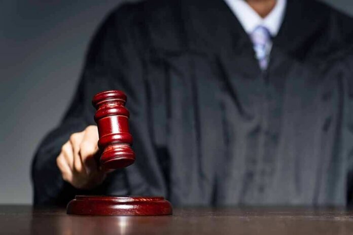 shutterstock_2250387095 Judge with gavel striking sound block