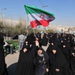 Funeral Fury: ‘Kill Trump’ Chants Erupt Group of women in black attire marching with an Iranian flag