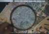 Magnifying glass highlighting Gaza on a digital map
