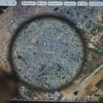 Magnifying glass highlighting Gaza on a digital map
