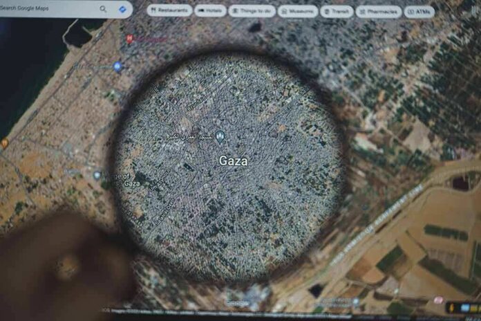 Magnifying glass highlighting Gaza on a digital map