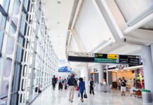 Forgotten Bullet, 12 Years: Caribbean Trap Interior of an airport terminal with travelers and signage