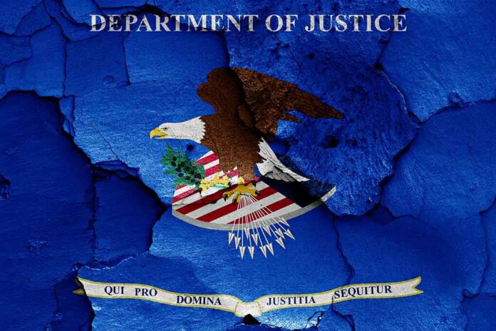 shutterstock_1168304080 Department of Justice emblem with eagle on blue cracked texture