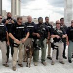Group of law enforcement officers with tactical gear and a K-9