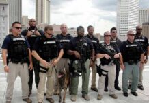 Group of law enforcement officers with tactical gear and a K-9