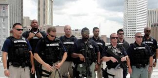 Group of law enforcement officers with tactical gear and a K-9