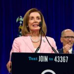 Pelosi Denies Knowing Biden Was Declining and Gushes Over Newsom woman in pink blazer speaking at a podium