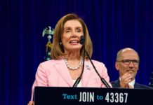 Pelosi Denies Knowing Biden Was Declining and Gushes Over Newsom woman in pink blazer speaking at a podium