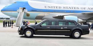 Presidential motorcade limousine parked beside large blue and white aircraft