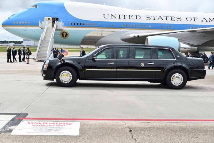 shutterstock_1822049969 Presidential motorcade limousine parked beside large blue and white aircraft