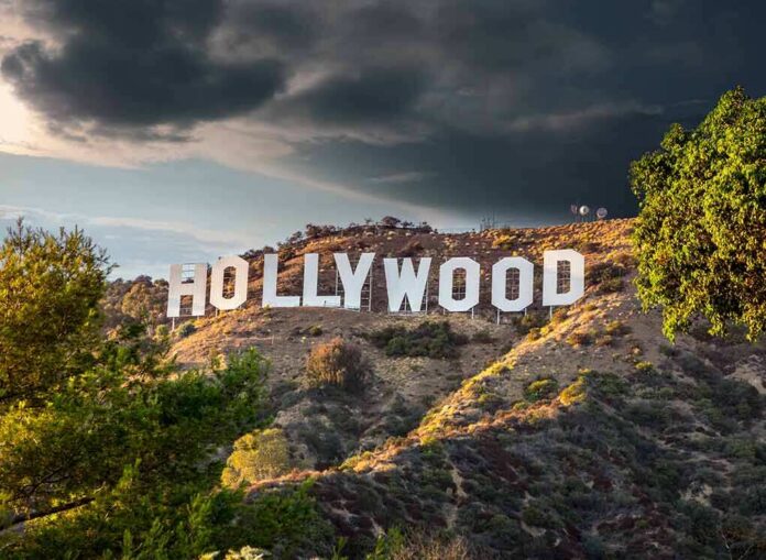 shutterstock_1832040724 Hollywood sign on hillside under dramatic clouds