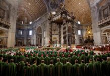 Clergy in green vestments gather under a grand baroque canopy in a vast cathedral