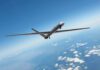 Unmanned aerial drone flying high above clouds