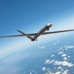 Unmanned aerial drone flying high above clouds