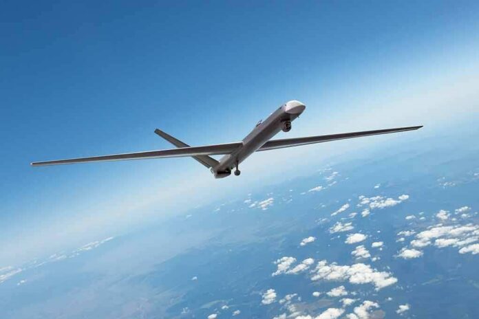 shutterstock_2138419037 Unmanned aerial drone flying high above clouds