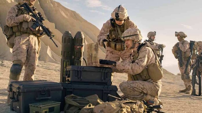shutterstock_675995524 Soldiers in desert setting prepare equipment near rugged hills