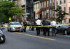 Cop Found Dead as ‘Armed and Dangerous’ Wife Disappears Police gathered at an urban crime scene.