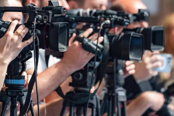 television cameras on tripods at a media event
