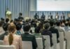 Audience listening to a panel discussion in a conference hall