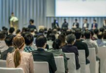 Audience listening to a panel discussion in a conference hall