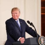 See What Trump Just Did for Irish Whiskey man at podium with presidential seal