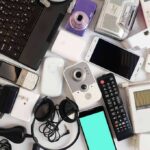 Assorted electronic gadgets and accessories on a white surface
