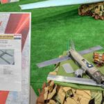 Small military drone displayed on a table with informational board