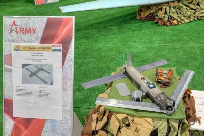 shutterstock_1191990448 Small military drone displayed on a table with informational board