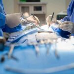 Surgeons performing an operation with instruments