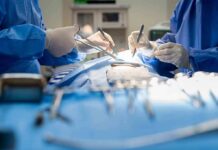 Surgeons performing an operation with instruments