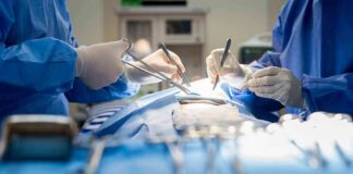 Surgeons performing an operation with instruments